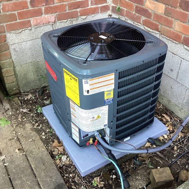 Armor Air technician installing a residential AC condenser unit